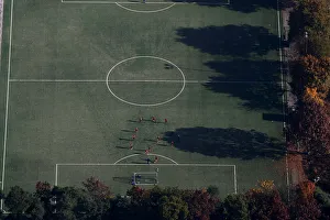 An aerial view shows soccer players standing on a field on a sunny autumn day in An aerial view shows soccer players standing on a field on a sunny autumn day in