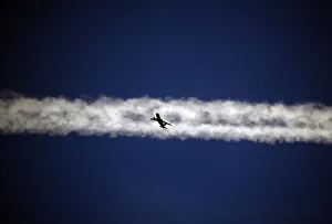 An aeroplane flies underneath the jet stream of another aircraft above the Italian city An aeroplane flies underneath the jet stream of another aircraft above the Italian city