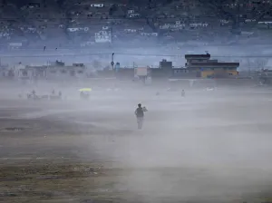 An Afghan man heads home walking through a dust cloud as the sun sets in Kabul An Afghan man heads home walking through a dust cloud as the sun sets in Kabul