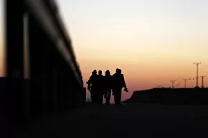 Images Dated 15th December 2013: African migrants walk on a road after choosing to permanently leave their open detention