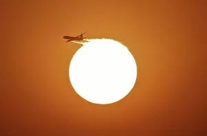 Images Dated 30th November 2013: An aircraft files near the setting sun in New Delhi