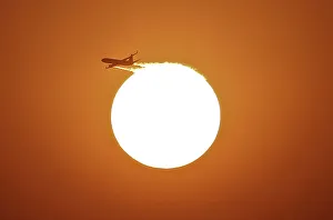 An aircraft files near the setting sun in New Delhi An aircraft files near the setting sun in New Delhi