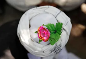 An artificial flower is seen on a turban of a peace marcher as he arrives in Kabul An artificial flower is seen on a turban of a peace marcher as he arrives in Kabul