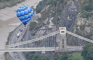 A balloon flies near the Clifton Suspension Bridge during a mass take off at the annual A balloon flies near the Clifton Suspension Bridge during a mass take off at the annual