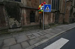 Balloons are attached to a street sign as a decoration for the carnival in the empty Balloons are attached to a street sign as a decoration for the carnival in the empty
