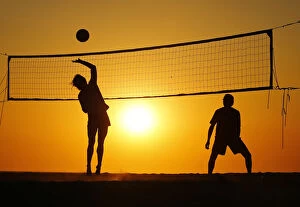 Sunlight Gallery: Beachgoers play volleyball at the beach as the sun sets in Carlsbad, California