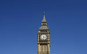 Big Ben Clock Tower above the Houses of Parliament is surrounded by blue sky in London Big Ben Clock Tower above the Houses of Parliament is surrounded by blue sky in London