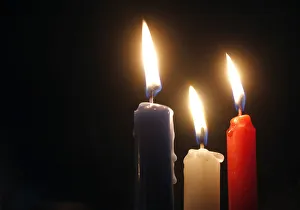 Blue, white and red candles in the colours of the French flag burn at the Place de la Blue, white and red candles in the colours of the French flag burn at the Place de la