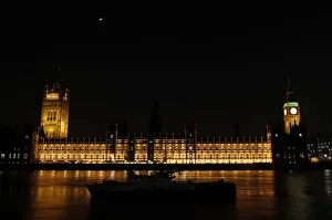 A boat is moored on the Thames across from the Houses of Parliament and Big Ben in London A boat is moored on the Thames across from the Houses of Parliament and Big Ben in London