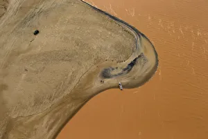 A boat is seen on the mouth of Rio Doce (Doce River), which was flooded with mud after A boat is seen on the mouth of Rio Doce (Doce River), which was flooded with mud after