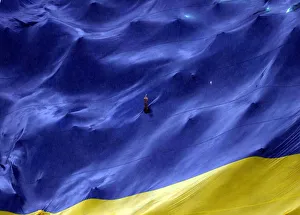 A Boca Juniors fan makes a gesture from a hole in a giant flag before their Argentine A Boca Juniors fan makes a gesture from a hole in a giant flag before their Argentine