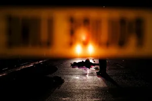 Bodies of two men are lit by a police car in Manila Bodies of two men are lit by a police car in Manila