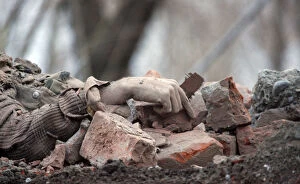 Images Dated 17th February 2010: The body of a suspected militant lies amongst rubble after a gun battle with the Indian