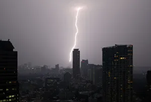 A bolt of lightning strikes over Tokyo skyscrapers at dusk in Tokyo A bolt of lightning strikes over Tokyo skyscrapers at dusk in Tokyo