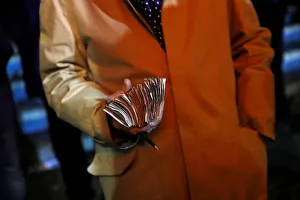 A bookmaker holds money before a greyhound race at Wimbledon Stadium in London A bookmaker holds money before a greyhound race at Wimbledon Stadium in London
