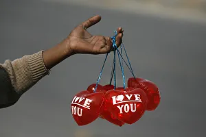 A boy holds Valentines Day balloons for sale along the roadside in Lahore A boy holds Valentines Day balloons for sale along the roadside in Lahore