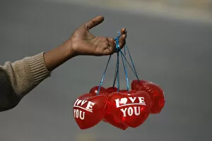 Images Dated 14th February 2010: A boy holds Valentines Day balloons for sale along the roadside in Lahore