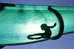 Images Dated 1st August 2013: A boy slides down a water chute in a public swimming pool in Thun