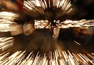Buddhist devotees light oil lamps at Gangaramaya temple as part of celebrations for the