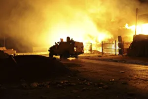 A building on fire, which witnesses say was hit by a rocket A building on fire, which witnesses say was hit by a rocket