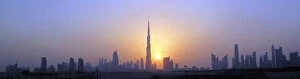 The Burj Khalifa is seen as the sun sets over Dubai