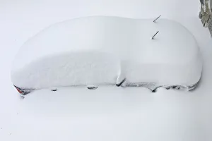 A car is buried in snow from an overnight snowstorm inside Washington DC Beltway in A car is buried in snow from an overnight snowstorm inside Washington DC Beltway in