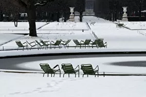 Empty chairs are seen in the snow-covered Tuileries Garden in Paris as winter weather