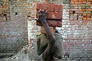 A child labourer carries bricks in Bihar-e-Sharif town A child labourer carries bricks in Bihar-e-Sharif town