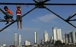 Indonesia Gallery: Children play at an electricity pylon in Jakarta