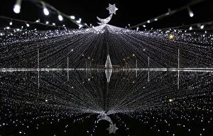 Images Dated 23rd December 2012: Christmas decorations are seen in front of a pond ahead of Christmas day celebrations in