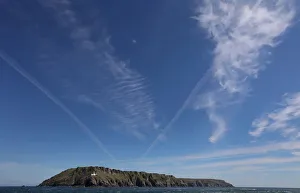 Cirrus clouds and contrails are seen above the island of Lundy Cirrus clouds and contrails are seen above the island of Lundy