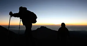 Climbers walk up the steep gravel and scree slope leading to the summit of Tanzania's Climbers walk up the steep gravel and scree slope leading to the summit of Tanzania's