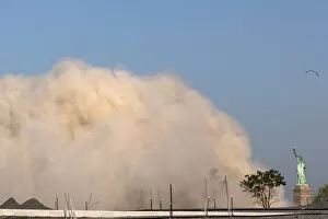 Images Dated 9th June 2013: A cloud of dust from a nearby imploded building approaches the Statue of Liberty in New