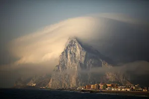 Cloud partially covers Rock of the British territory of Gibraltar at sunrise before Cloud partially covers Rock of the British territory of Gibraltar at sunrise before