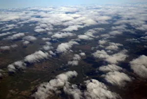 Clouds and land are seen from an atmospheric research aircraft en route to the Norwegian Clouds and land are seen from an atmospheric research aircraft en route to the Norwegian