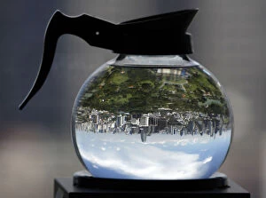 Images Dated 25th August 2009: A coffee pot filled with water acts as a lens to depict Lumpini Park in Bangkok