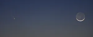 The comet PANSTARRS is seen next to the waxing crescent moon off the western coast of The comet PANSTARRS is seen next to the waxing crescent moon off the western coast of