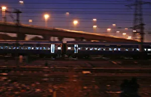 A commuter stands on the doorsteps of a moving train in New Delhi A commuter stands on the doorsteps of a moving train in New Delhi