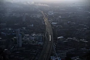 Commuter trains are seen at dawn on the approach to London Bridge rail station in Commuter trains are seen at dawn on the approach to London Bridge rail station in