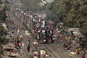 Commuters ride on the roof of a train as they come back to the city after attending Commuters ride on the roof of a train as they come back to the city after attending