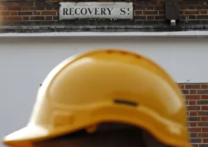 A construction worker walks past a street sign in south London A construction worker walks past a street sign in south London