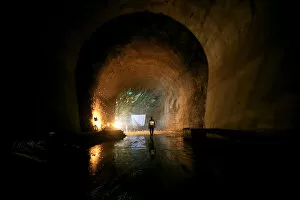 A contractor walks in a tunnel at the construction site at Karuma 600 megawatts