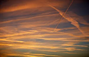Contrails from a passenger plane is seen during the sunset in Berlin Contrails from a passenger plane is seen during the sunset in Berlin