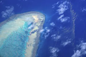 Coral surrounds a small island on the Great Barrier Reef, located off the coast of Queensland Coral surrounds a small island on the Great Barrier Reef, located off the coast of Queensland