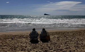 Images Dated 25th March 2013: A couple relaxes as they sunbath on a beach during a sunny day in Benidorm