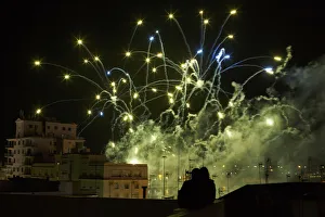 A couple watches fireworks from a terrace during the Carnival of Cadiz, southern Spain A couple watches fireworks from a terrace during the Carnival of Cadiz, southern Spain