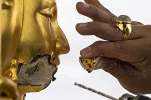 A craftsman fixes the statue of Hindu god Brahma after it was damaged during the deadly A craftsman fixes the statue of Hindu god Brahma after it was damaged during the deadly