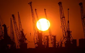 Cranes of German shipyard Blohm&Voss are silhouetted during sunset in Hamburg Cranes of German shipyard Blohm&Voss are silhouetted during sunset in Hamburg