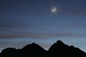 A crescent moon is pictured above mountains at the Kleine Scheidegg in Wengen January A crescent moon is pictured above mountains at the Kleine Scheidegg in Wengen January