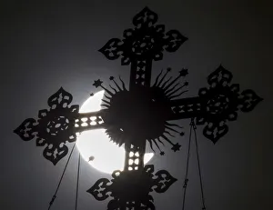 A cross on the dome of the Cathedral of Christ the Saviour is seen during a partial solar A cross on the dome of the Cathedral of Christ the Saviour is seen during a partial solar
